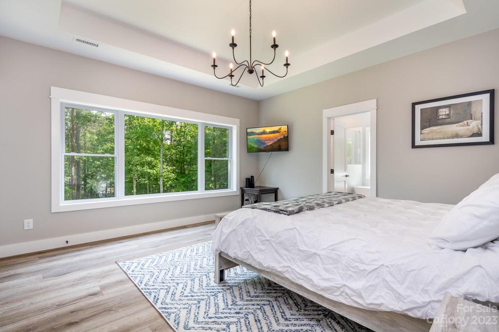 Primary bedroom with views of lake