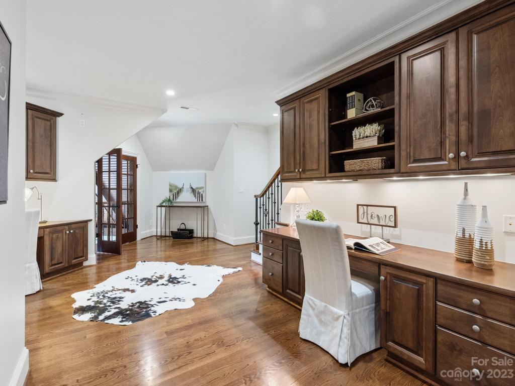 2nd floor study w/2 built in desks and juliet balcony.  Stairs lead to 3rd level.