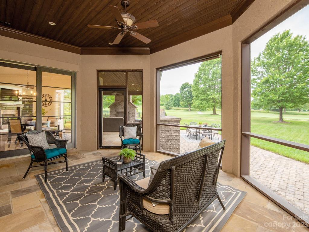 Screened in porch has access to living room, kitchen and covered porch w/ built in grill.