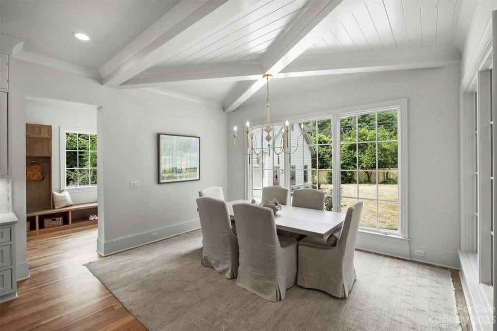 The dining area sits off the kitchen, flaunting impressive coffered ceilings and intricate shiplap details.