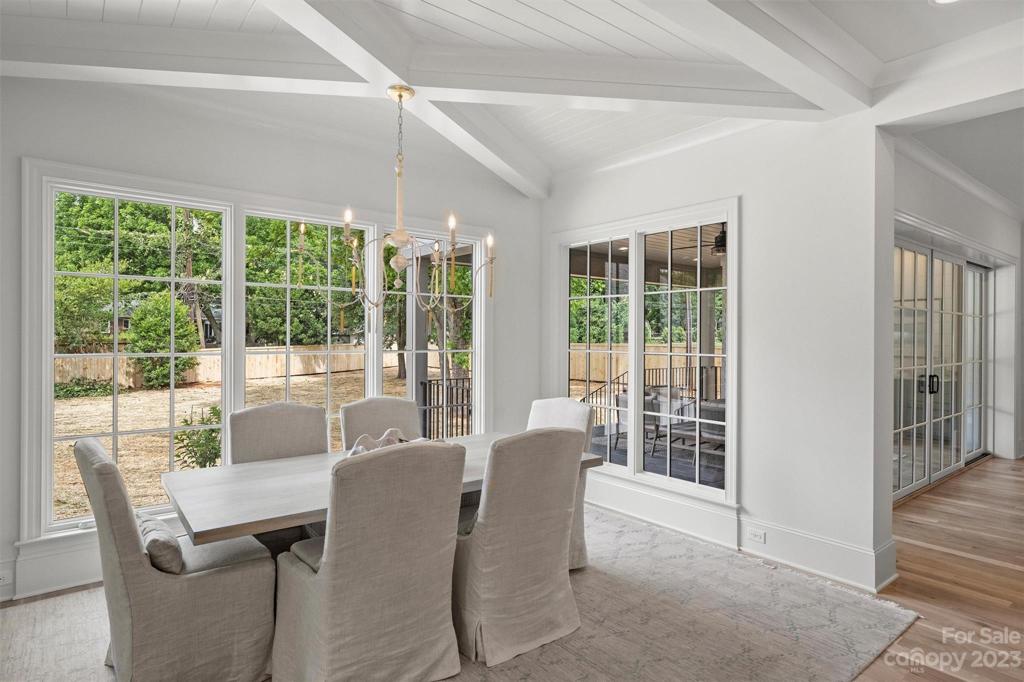 Abundant natural light floods the dining area with large windows looking onto the lovely covered patio and large outdoor space.
