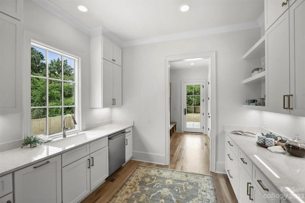 Scullery sits adjacent to the kitchen, convenient for additional preparation and storage.