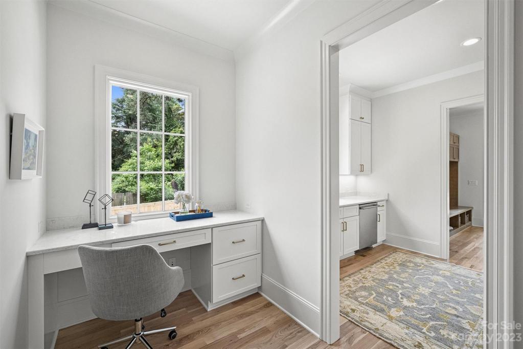Work station with built-in desk, conveniently located off kitchen for easy access throughout the day.
