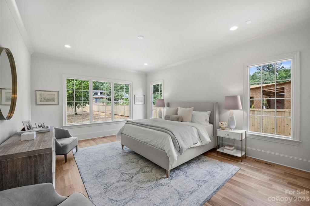 Retreat to the private, main-level primary suite, boasting 10' ceilings and custom trim and mouldings.