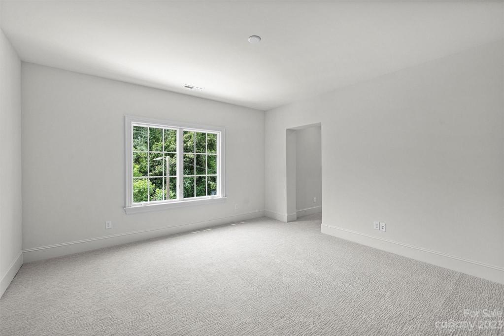Bedroom 5 with its own walk-in closet and ensuite bathroom.