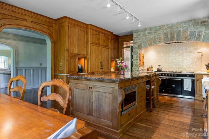 (*Note the beautifully built-in Sub-Zero refrigerator/freezer in the background along with the coffee niche!) This convenient island also supplies a microwave, storage...and...