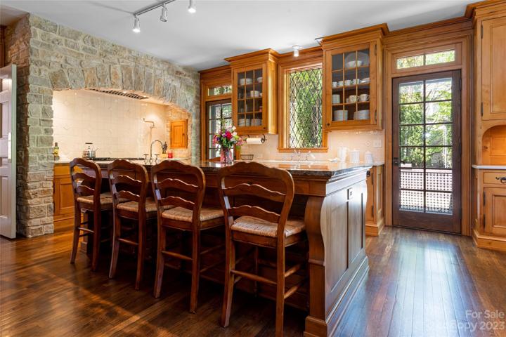 Voila! We'll begin with this magnificent handmade (by Carl Giesenschlag) butternut/white walnut Regency style kitchen island that provides bar seating...and so much more...such as...