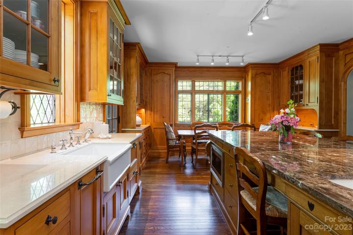 This amazing porcelain apron front farmhouse sink - with Herbeau faucets! - is flawless. It is accompanied by two Fisher & Paykel dishwashing drawers.