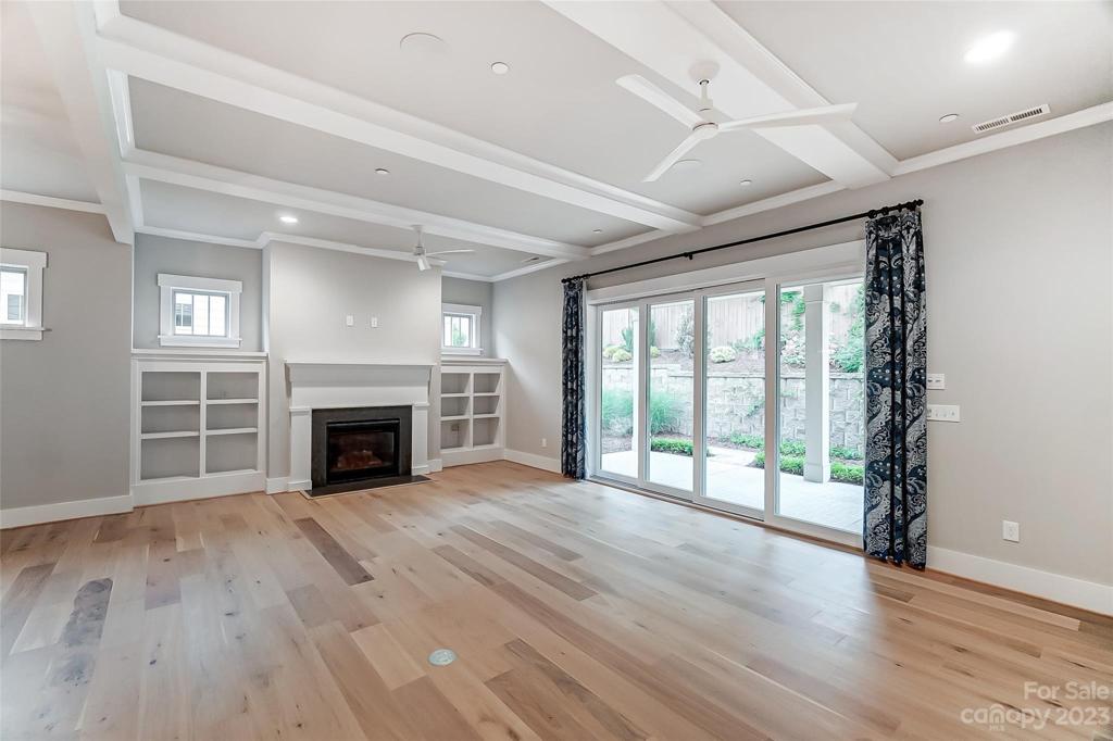 Great room with molding and recessed lights, hardwood floors & multi-slide door to let the outside in.