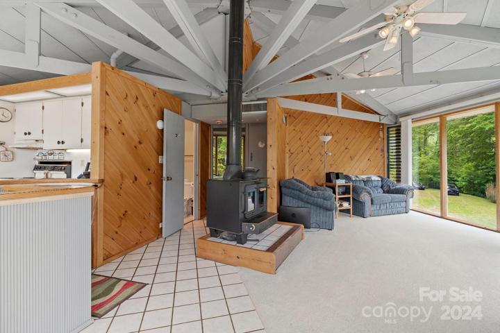 Upper/main level family room with wood burning stove. Notice the large windows to enjoy the year round view.