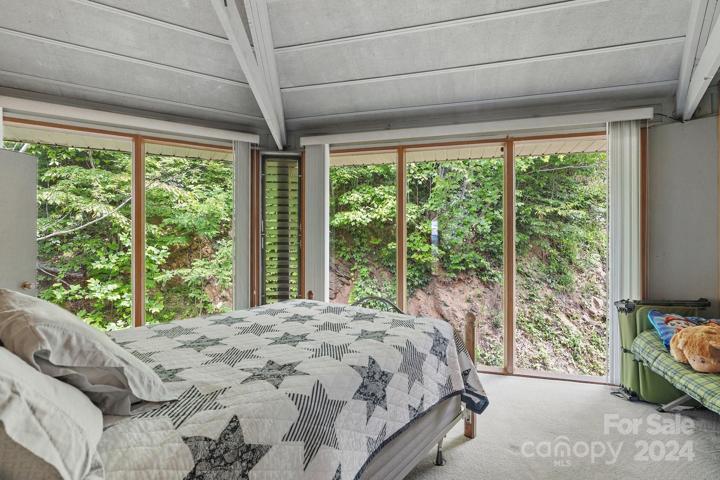 Primary bedroom on upper/main level; there is an ensuite full bathroom and walk in closet.