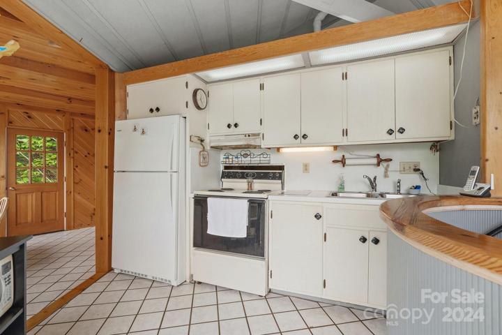 Tiled kitchen floor and all appliances to remain. Open concept.