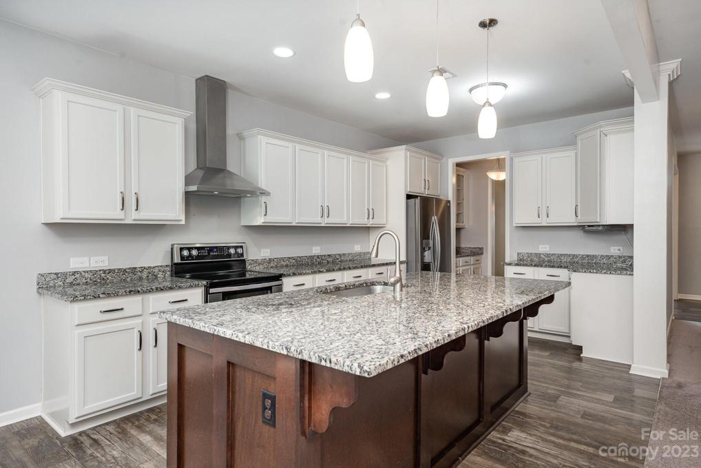 The stunning island accommodates three counter height chairs. You'll love the upgraded soft close drawers in kitchen and the kitchen trash drawer.