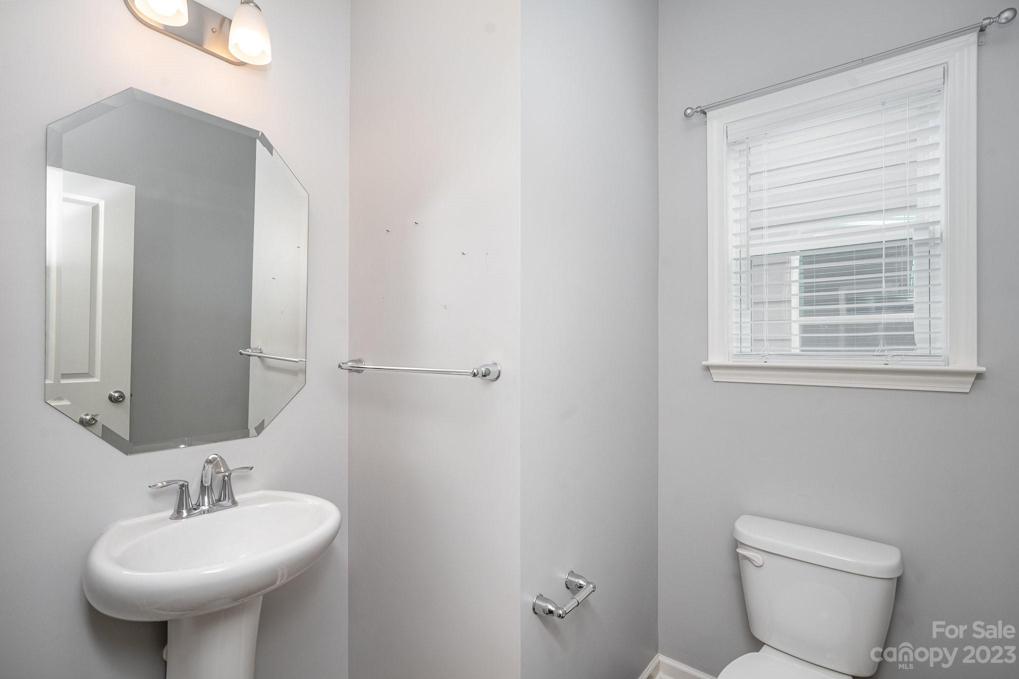 Main Level Powder room next to office and garage entry