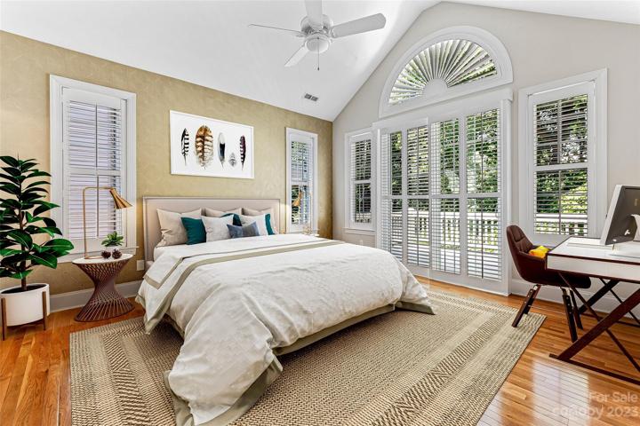 Primary suite with doors to the upper deck and mountain views. Virtually staged.