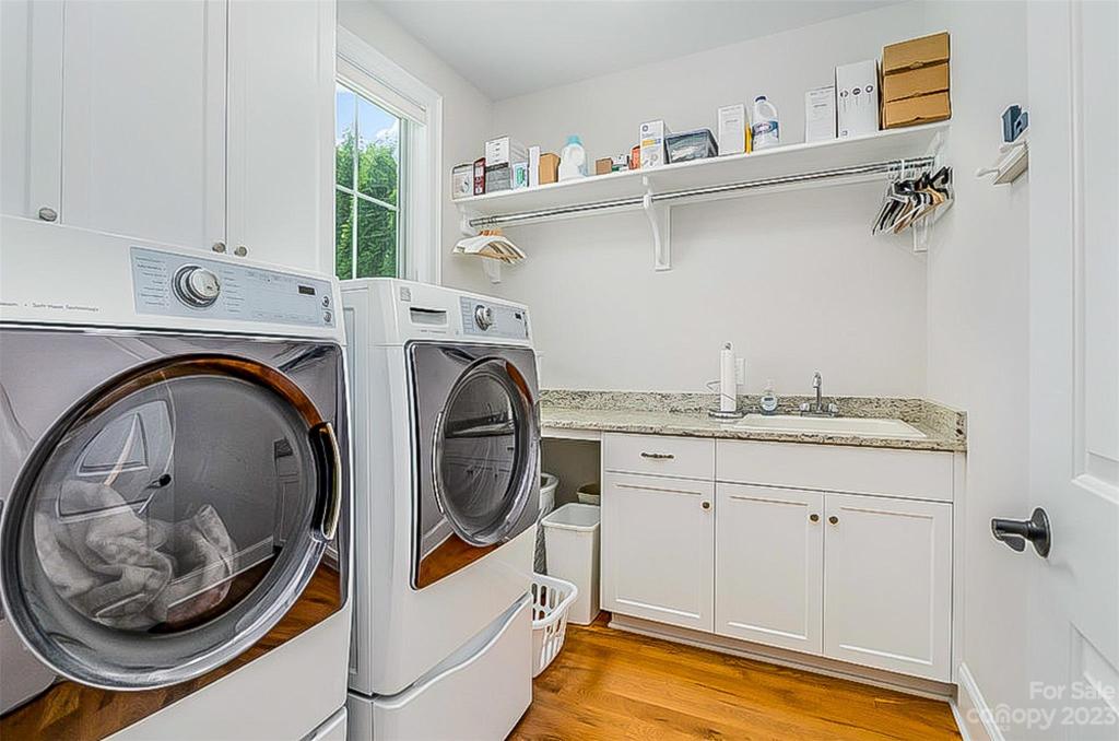 Laundry with laundry sink and built-ins.