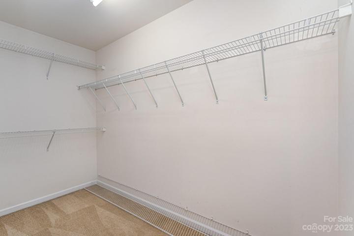 Primary bedroom walk in closet