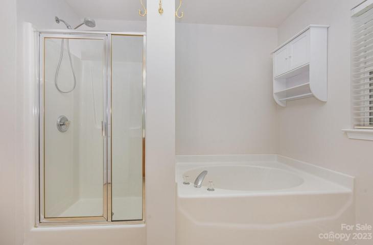 Primary bath includes walk-in shower & tub