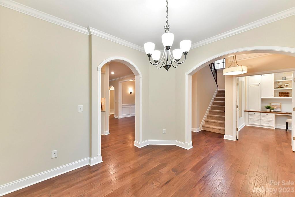 Breakfast Room with Crown Moldings and Arched Entries