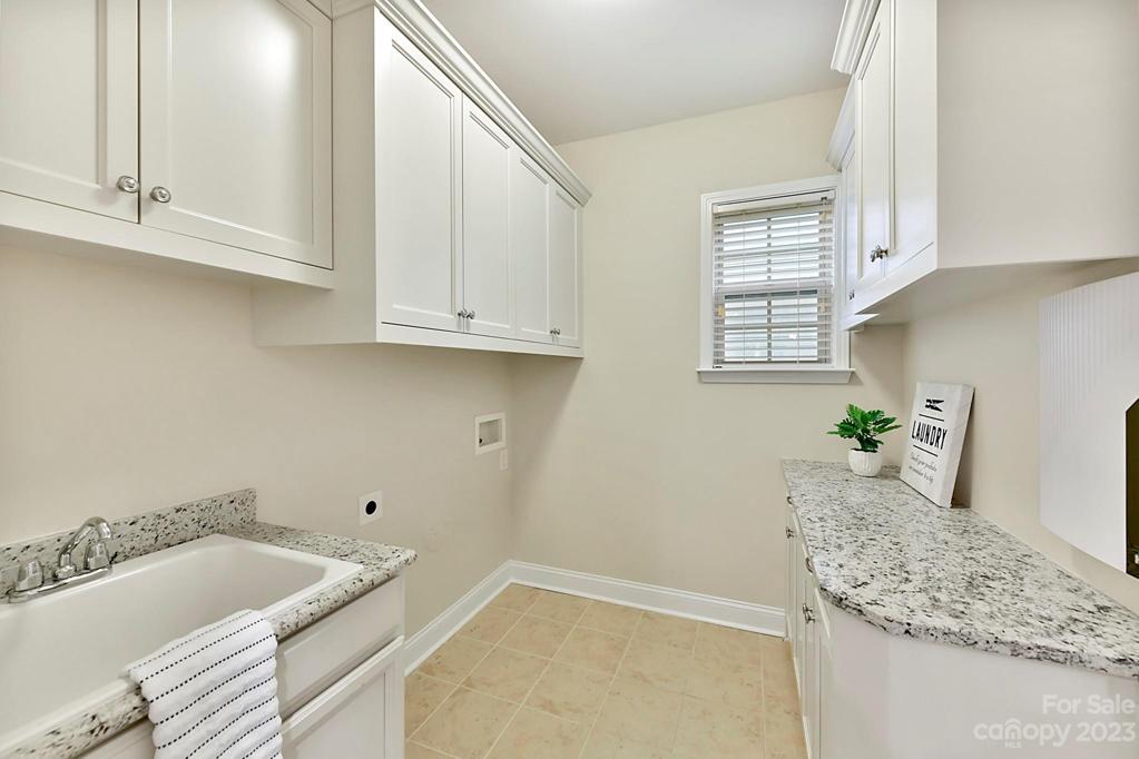 Laundry Room with Granite Counters, Utility Sink and Cabinets