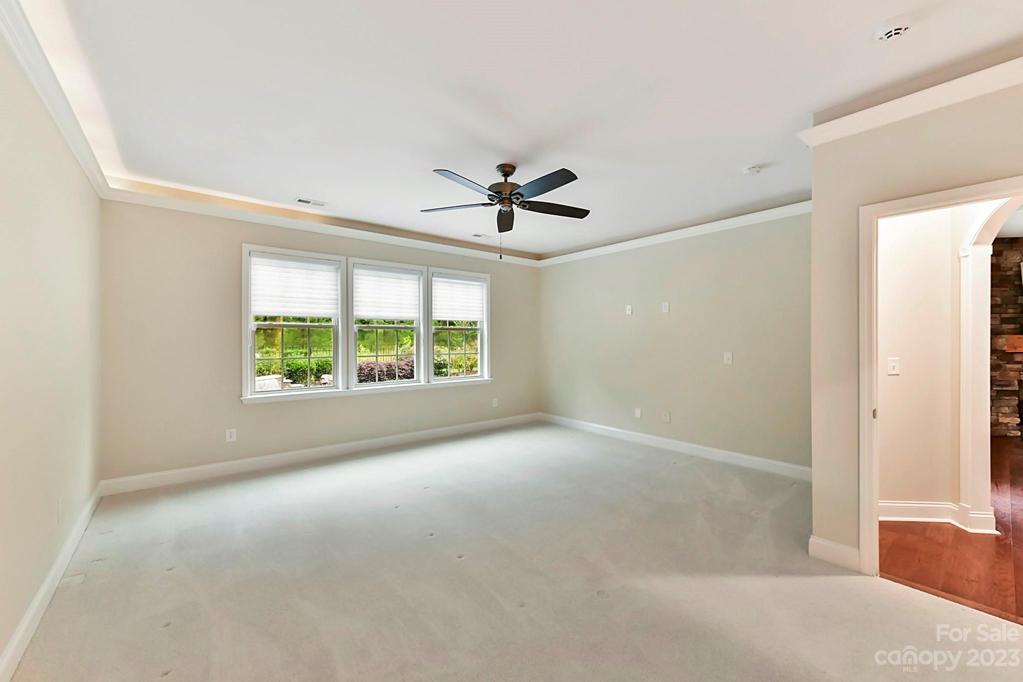 Primary Bedroom with Fan and Rope Lighting in Tray Ceiling