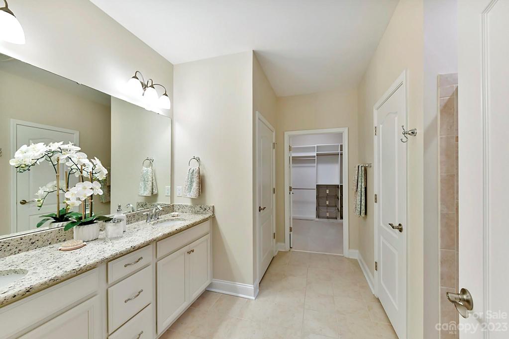 Primary Bath with Granite Counters, Tiled Flooring and Roll out Cabinet Drawers