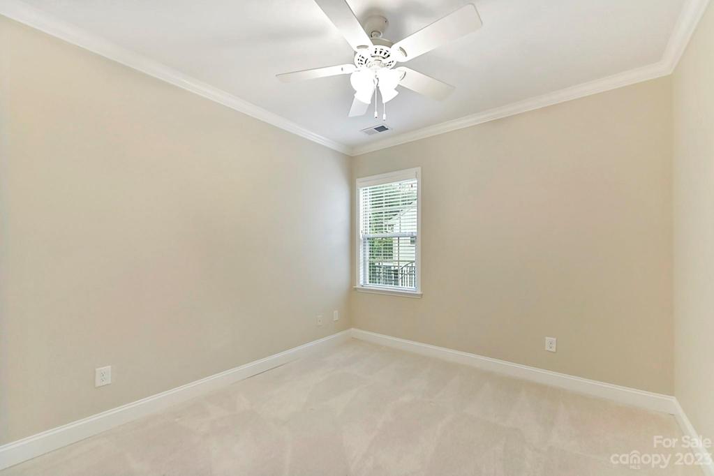 Main Level Bedroom 2 with Crown Moldings and Fan