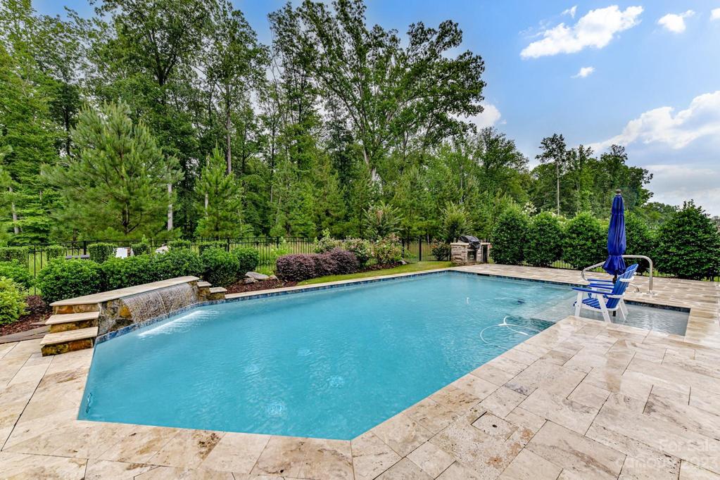 Inground Pool with Plenty of Pool Decking, Waterfall, and Tanning Ledge