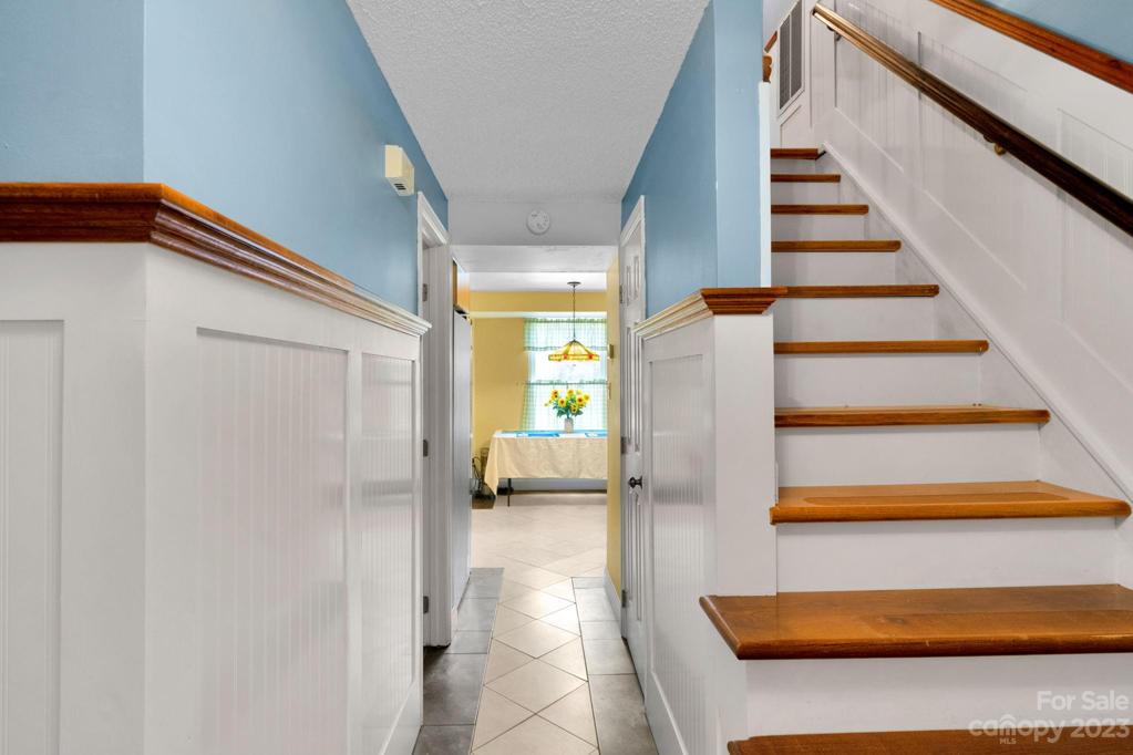 Entrance foyer at front door looking at breakfast nook & stairs to 2nd Floor
