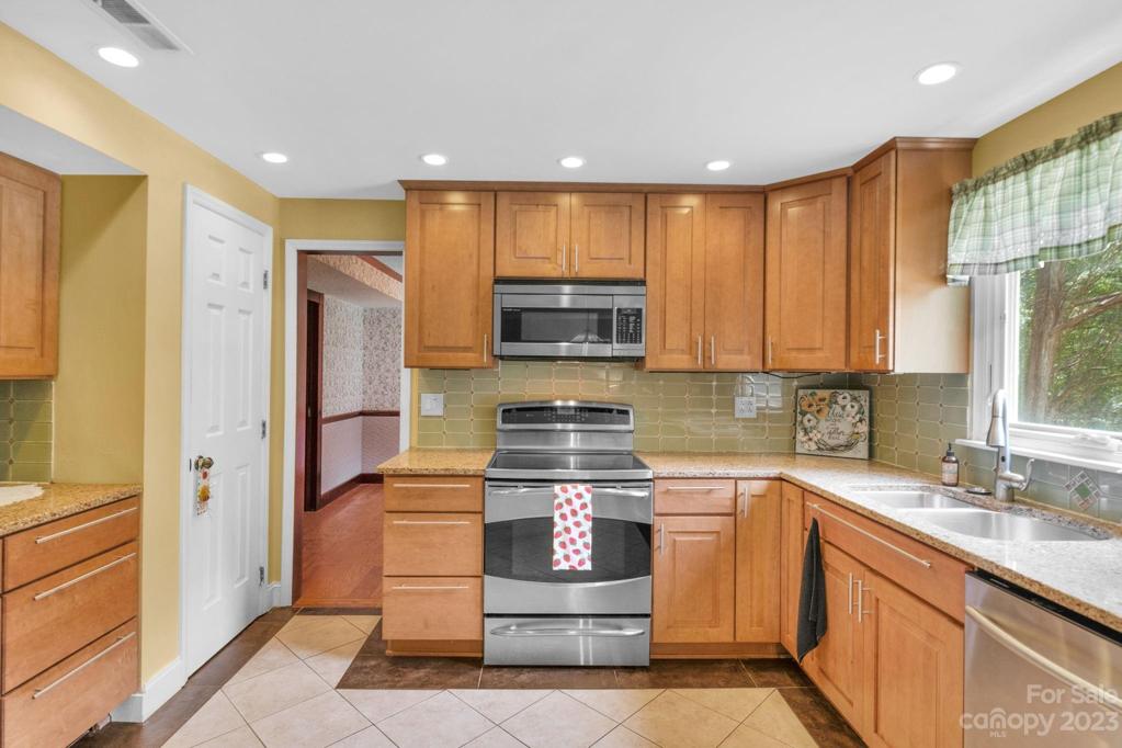 Kitchen has stainless steel appiiances and sink