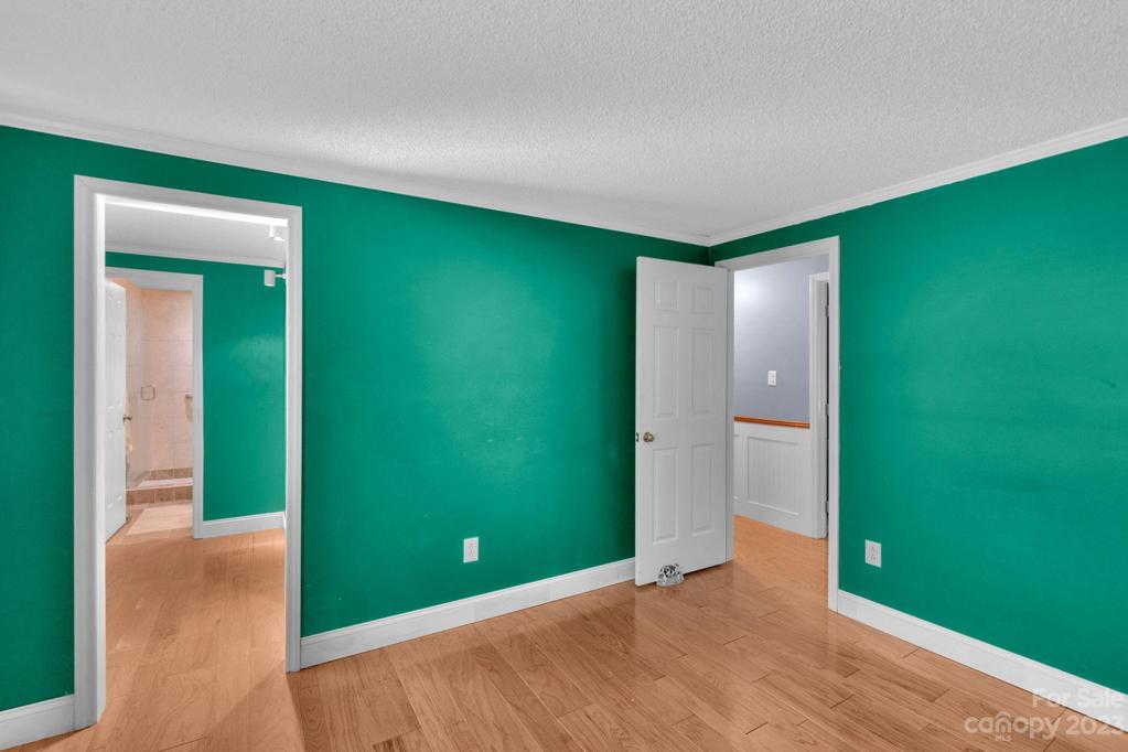 View of primary BR walkin closet and remodeled bathroom