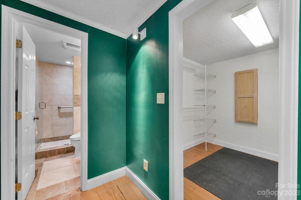 Walk in closet 7'6"x8"0" has fold down ironing board