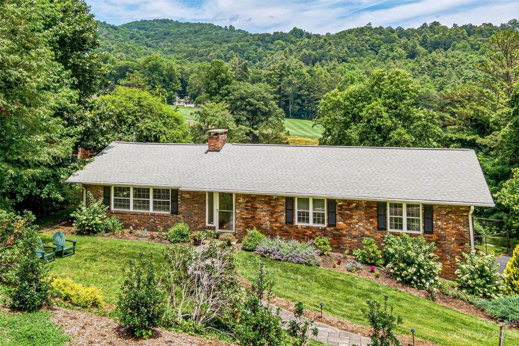 Prime location in heart of Sherwood Heights overlooking 16th fairway of The Asheville Country Club.