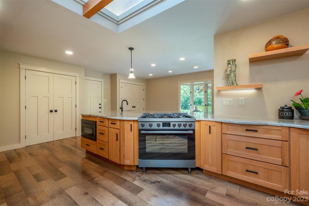 Brand new kitchen with Bosch appliances. Gas cooktop and double ovens make this a dream kitchen for a chef! The double doors on the left are the doors to the laundry room, the middle door is the entrance to the garage, and the double doors on the right are for the pantry.