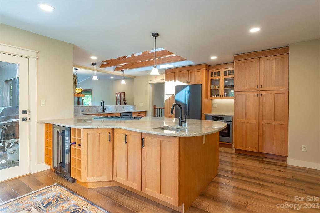 Beverage refrigerator and built in wine rack complete this side of the peninsula.