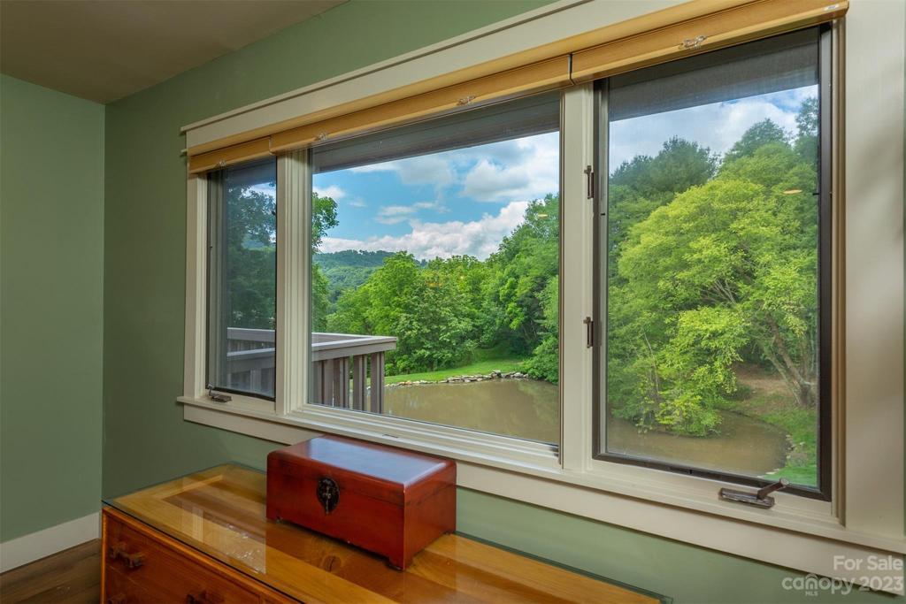 The spacious primary bedroom overlooks the pond where you can watch daily wildlife. There is a family of geese that bring their goslings to swim most days, before setting off for the country club pond.