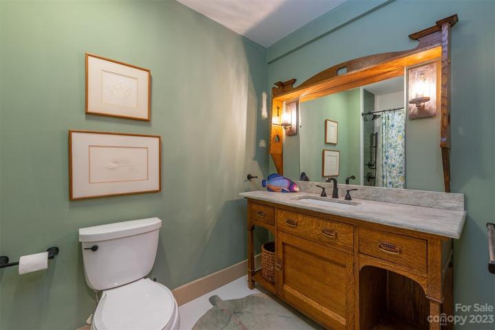 Lower level full bathroom has a tub and shower. The tub was re-glazed in a fun vibrant green! The reason it was not replaced is the tub is extra wide, which is challenging to find.