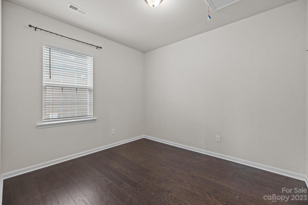 Bedroom 3 with great lighting and wood flooring