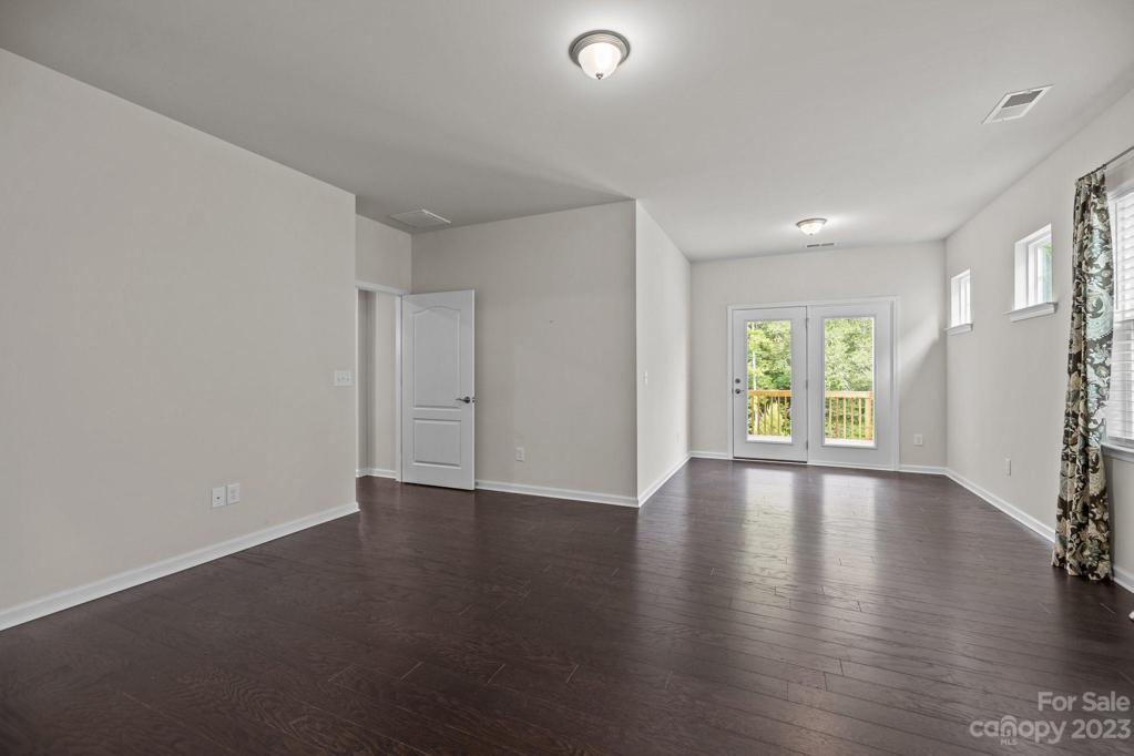 Sitting room off the primary bedroom with a door leading out to the back porch