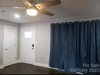 Living Room with coat closet and refinished wood floor