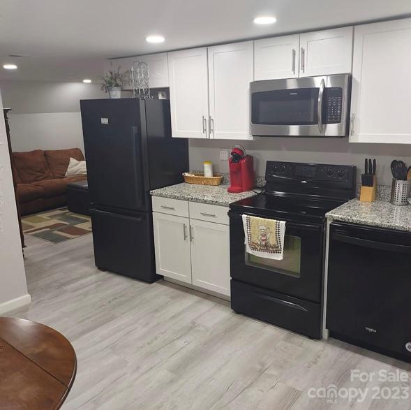 Apartment kitchen with new cabinets and granite counterops