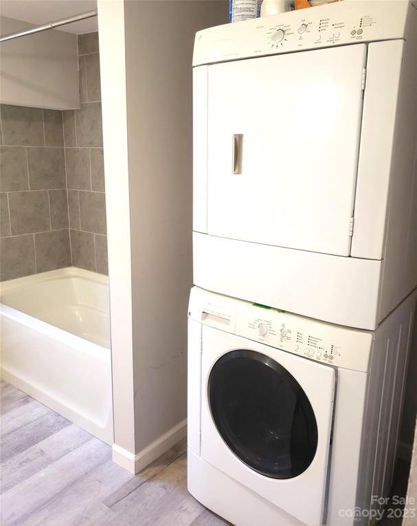 Apartment full bath with tiled tub shower and laundry