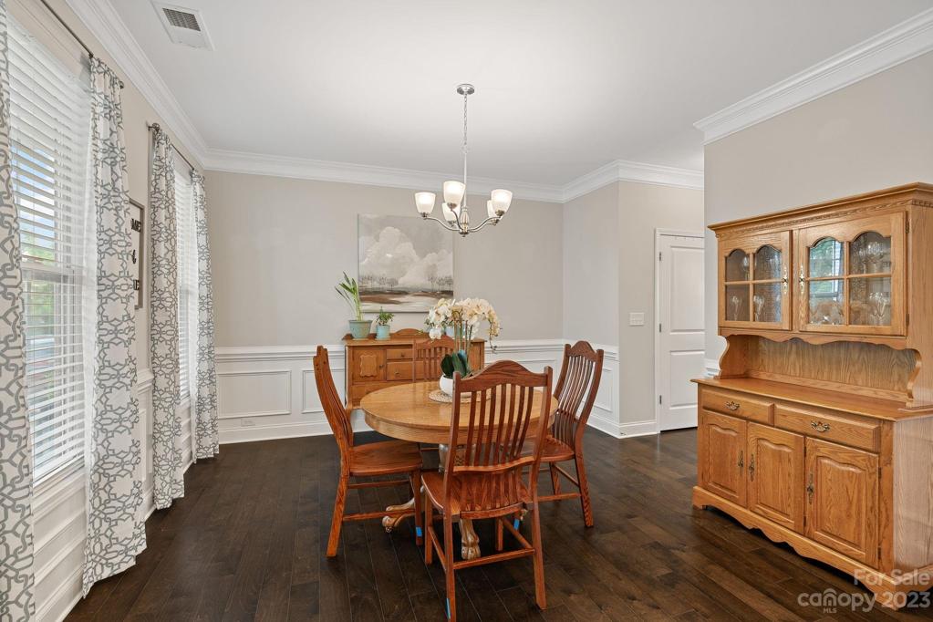 Formal dining room with crown molding and walk-through to kitchen.
