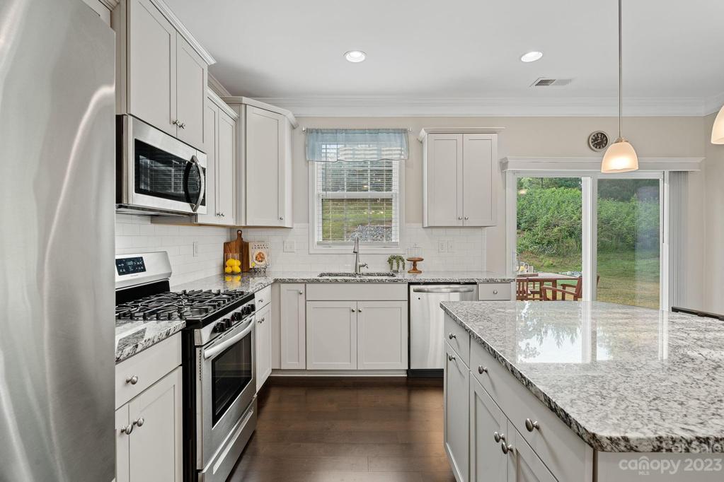 Stainless steel appliances, GAS stove, sink overlooking the lovely backyard.