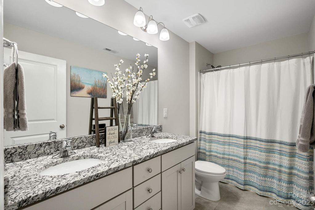 Guest bath on upper level has dual vanity and granite!