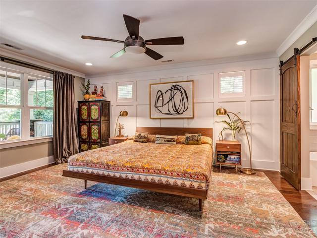 Primary Bedroom with Recessed Lights, Hardwoods, Custom Molding, Custom Blinds, and Large Windows overlooking your Private FRONT Yard!