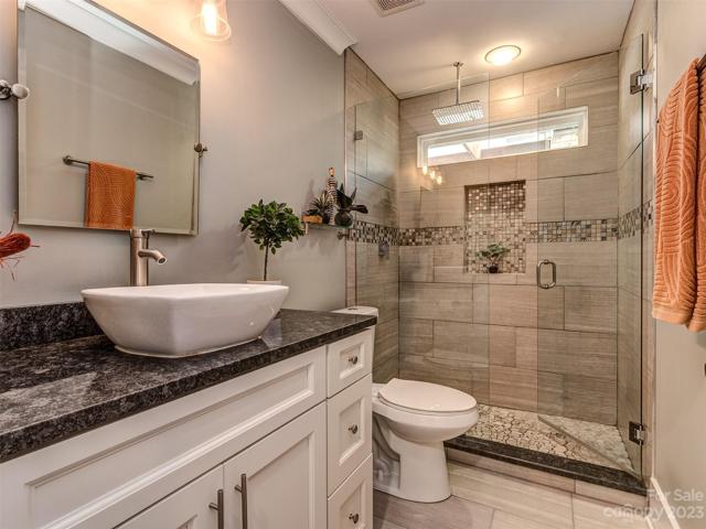 Guest Bath with Custom Tiled Shower, Granite Countertop, Custom Vanity, & Tile Flooring