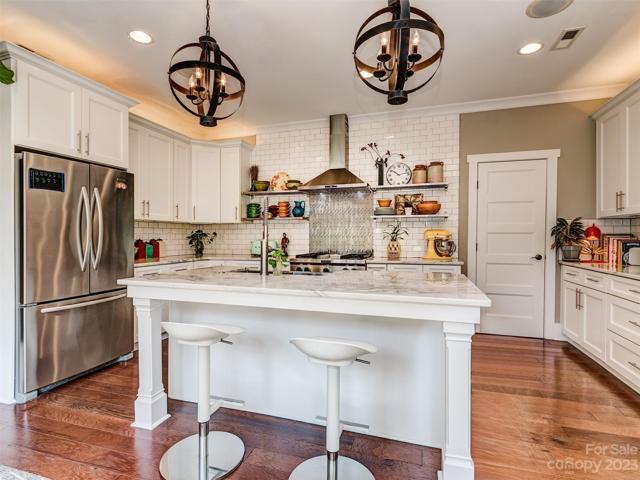 Gourmet Kitchen with Stainless Appliances, Marble Countertops, Island, Gas Cooktop, Wall Oven, Subway Tile Backsplash, Recessed Lights, Built-In Speakers and More!