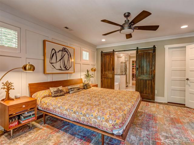 Primary Bedroom with Recessed Lights, Hardwoods, Custom Molding, Custom Blinds, and Large Windows overlooking your Private FRONT Yard!