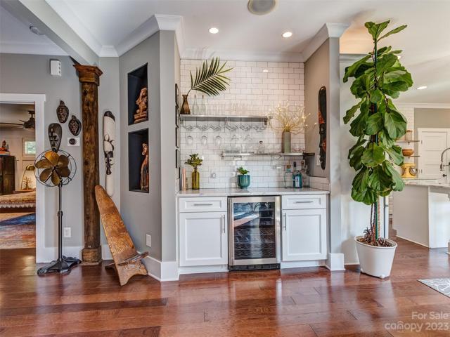 Custom Wet Bar with Beverage Fridge, Marble Counters, Cabinets, & Subway Tile